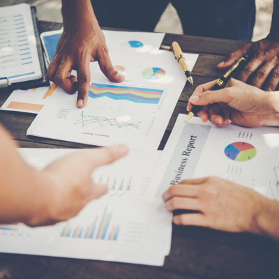 Group of business people analysis with marketing report graph, Young specialists are discussing business ideas for new digital start up project.